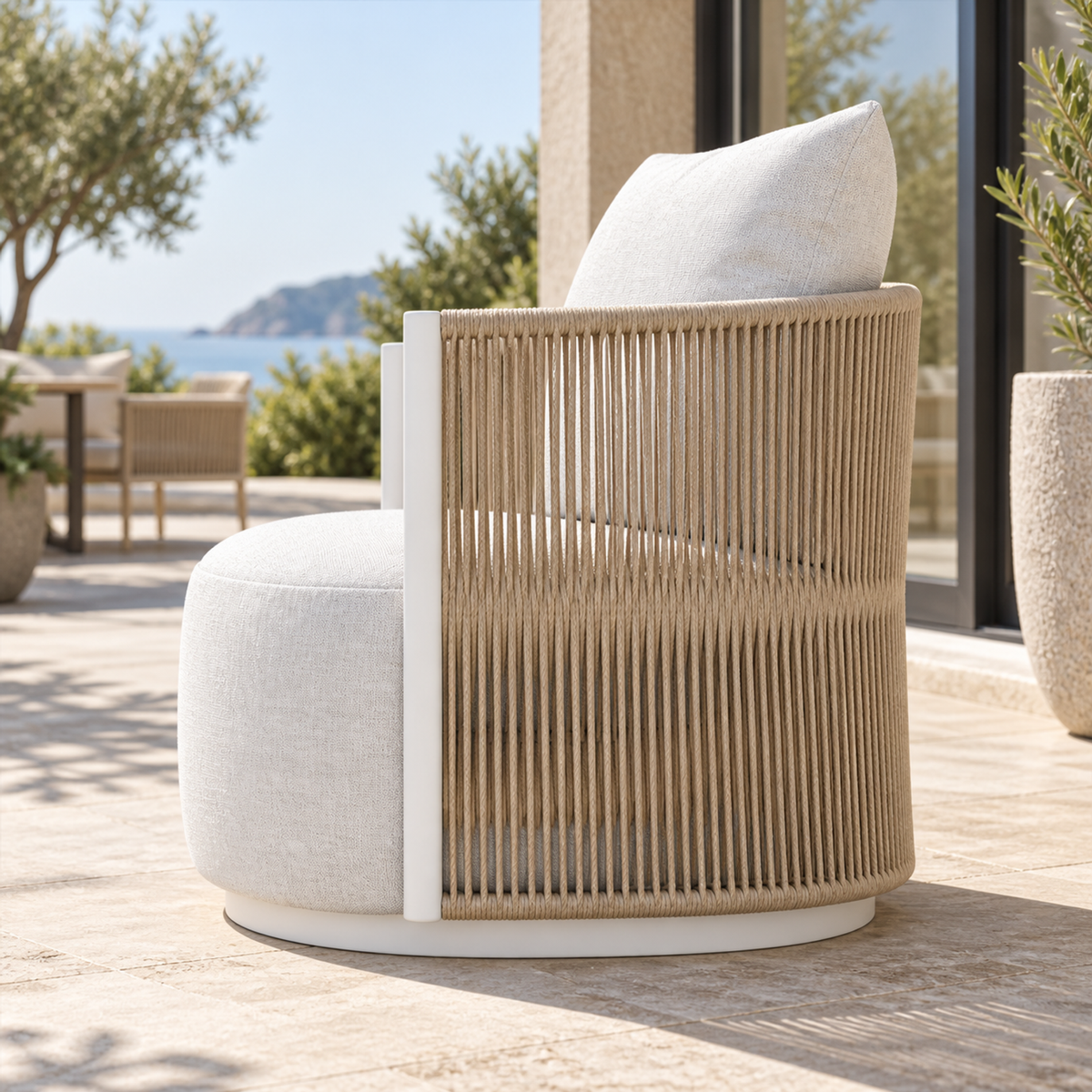 Lifestyle view: Ripple Lounge Chair in Aluminium, side profile on a coastal terrace