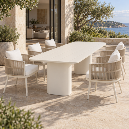 Ripple aluminium dining set, short-end view beside a furnished coastal home