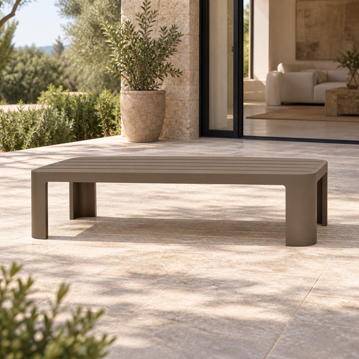 Serein aluminium coffee table, front view beside a furnished home