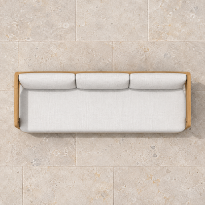 Serein teak sofa, overhead view on a stone home terrace
