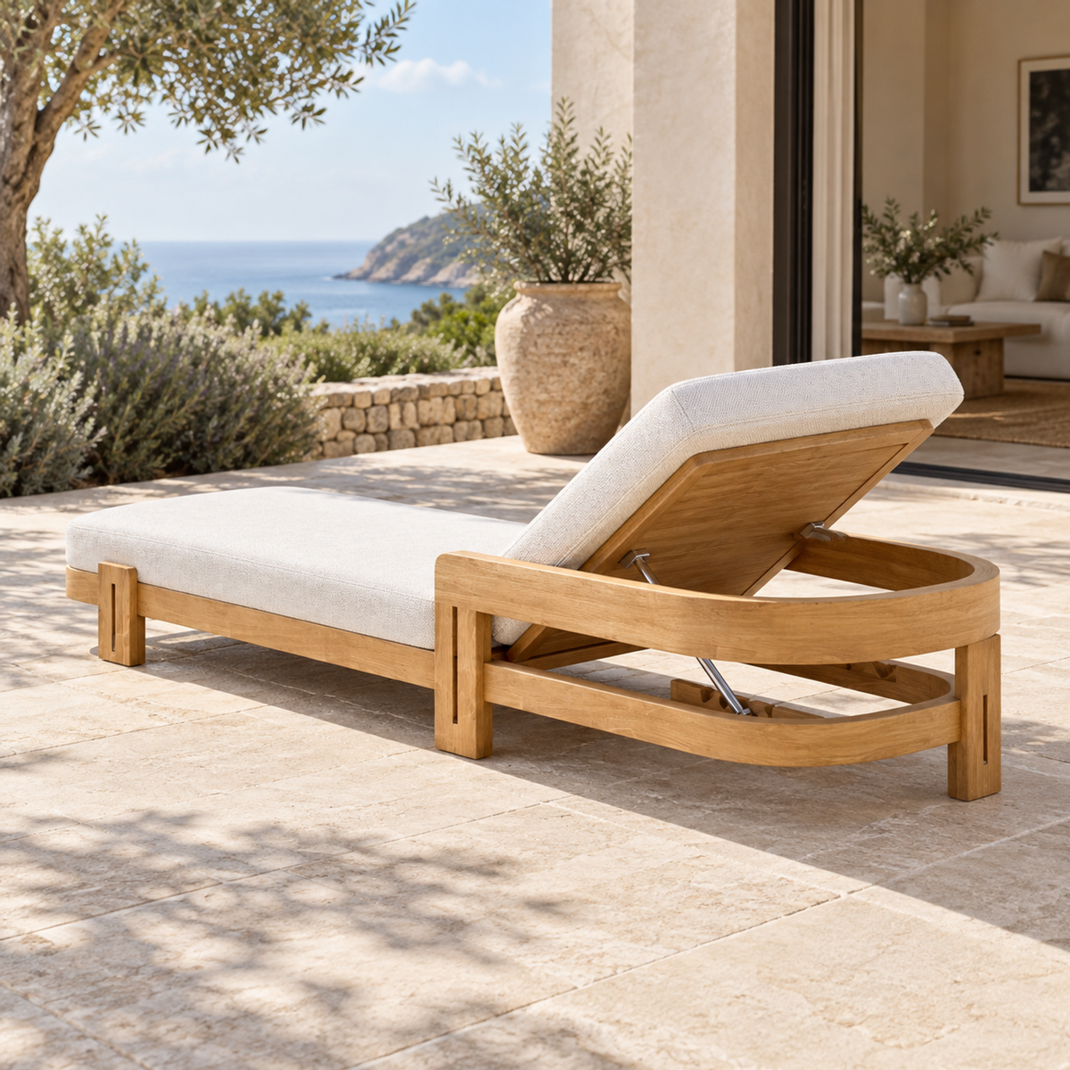 Serein teak sun lounger, rear diagonal on a furnished coastal terrace