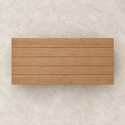 Vela teak coffee table, overhead view on a stone terrace