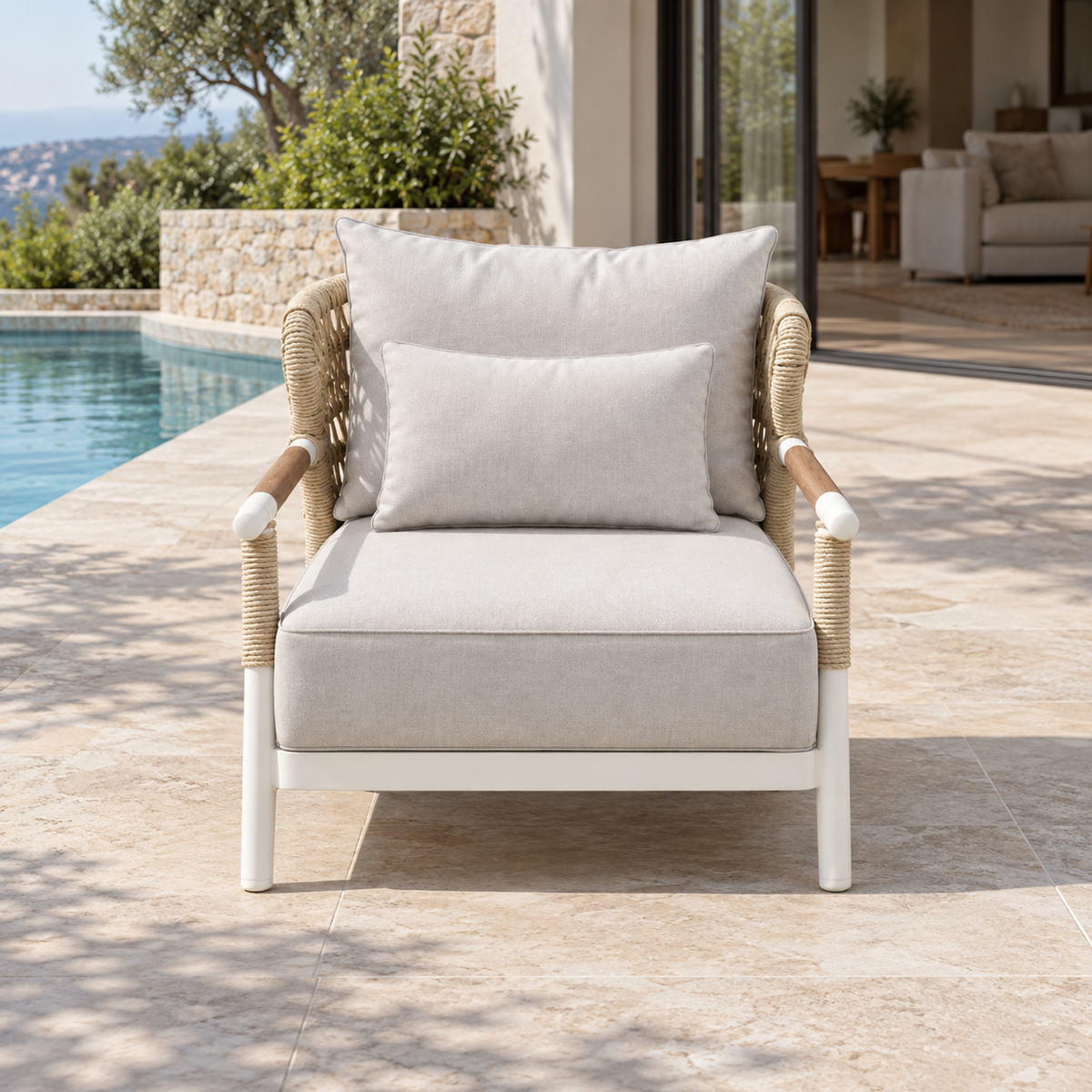 Lifestyle view: Vela Lounge Chair in Aluminium, photographed on a furnished outdoor terrace