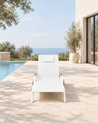 Vela Poolside Sun Lounger in Aluminium in a styled setting